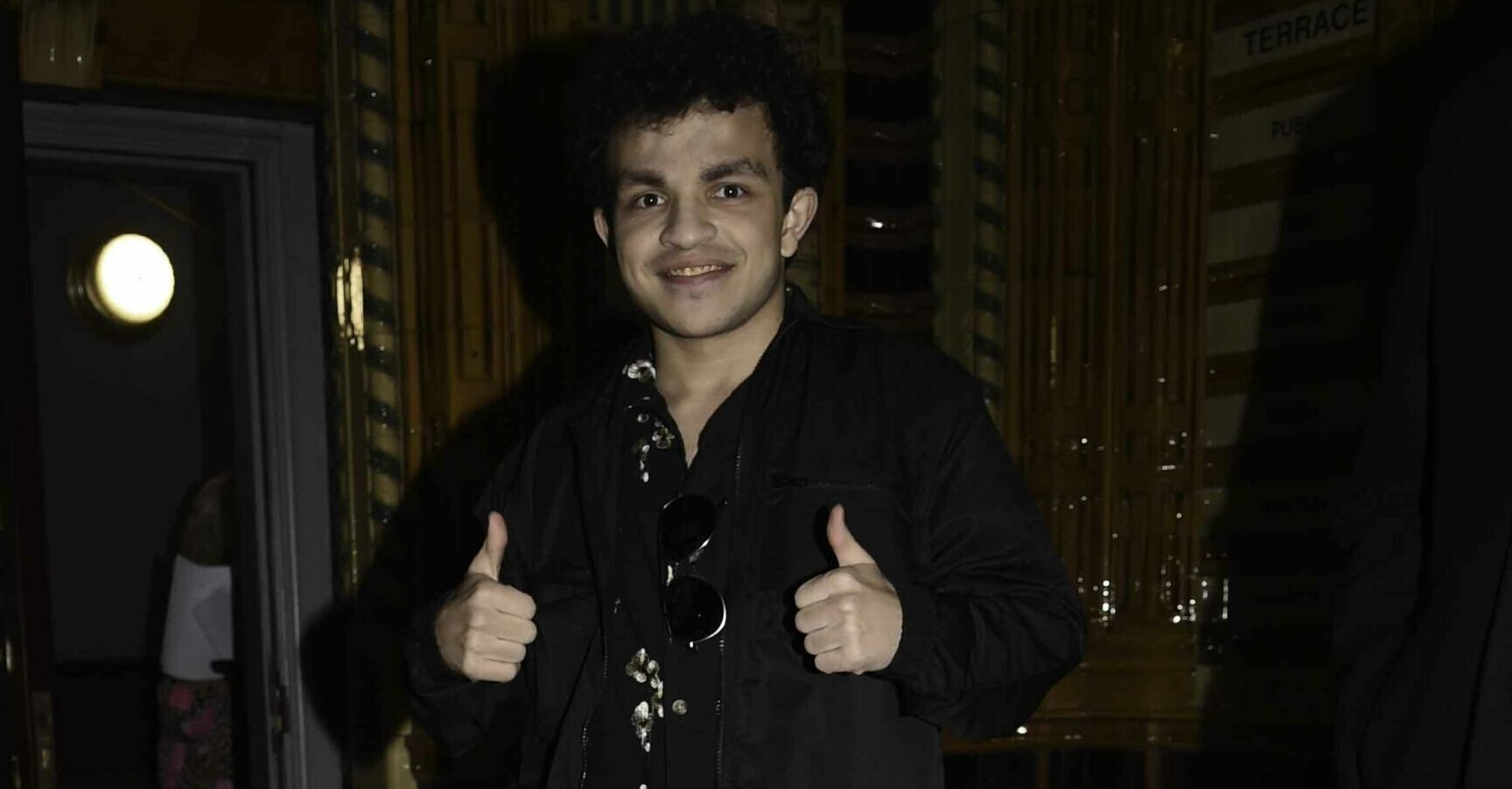 Alex Bain does thumbs up at the Coronation Street Christmas party