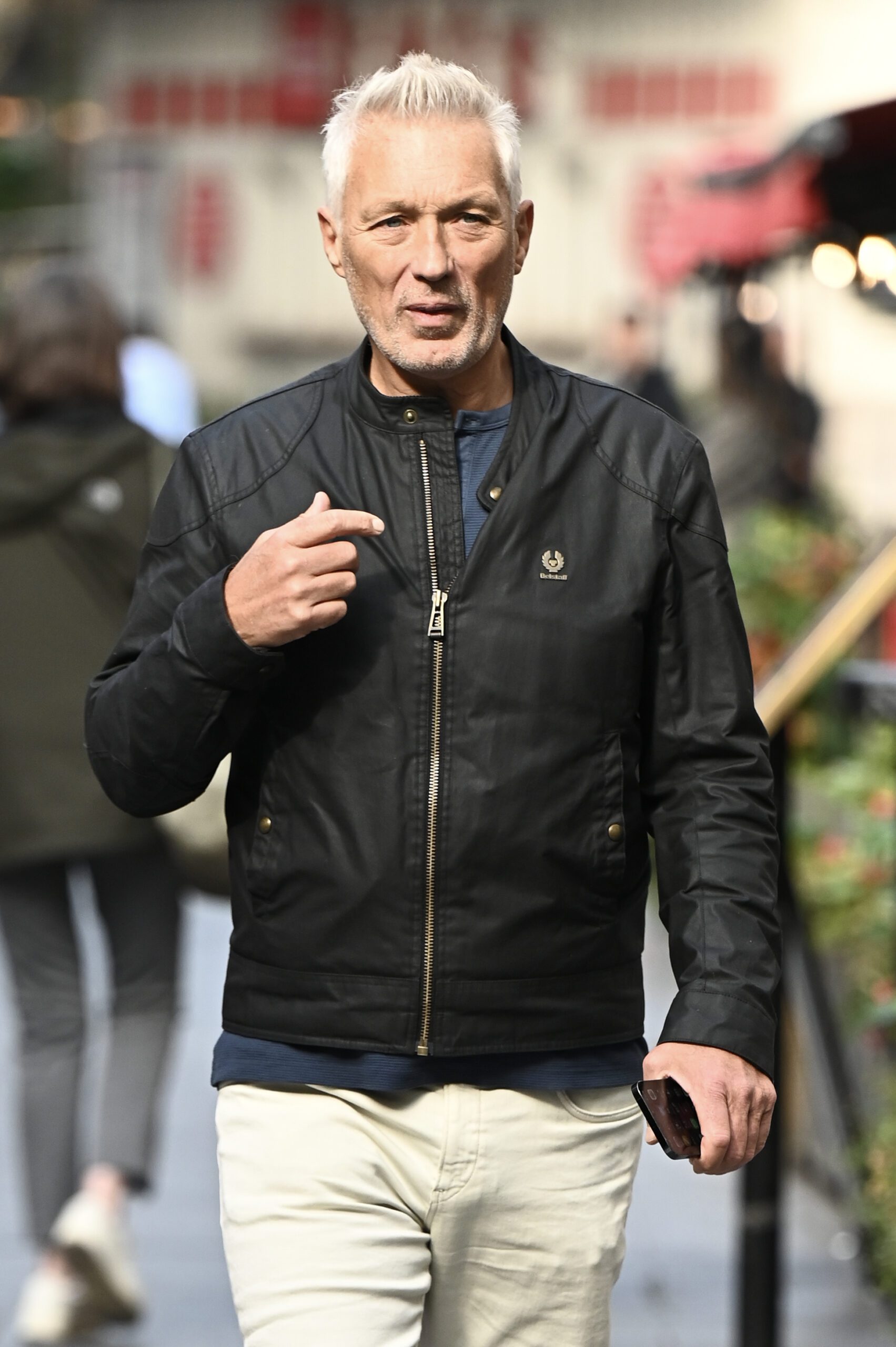 Martin Kemp straight faced walking in London