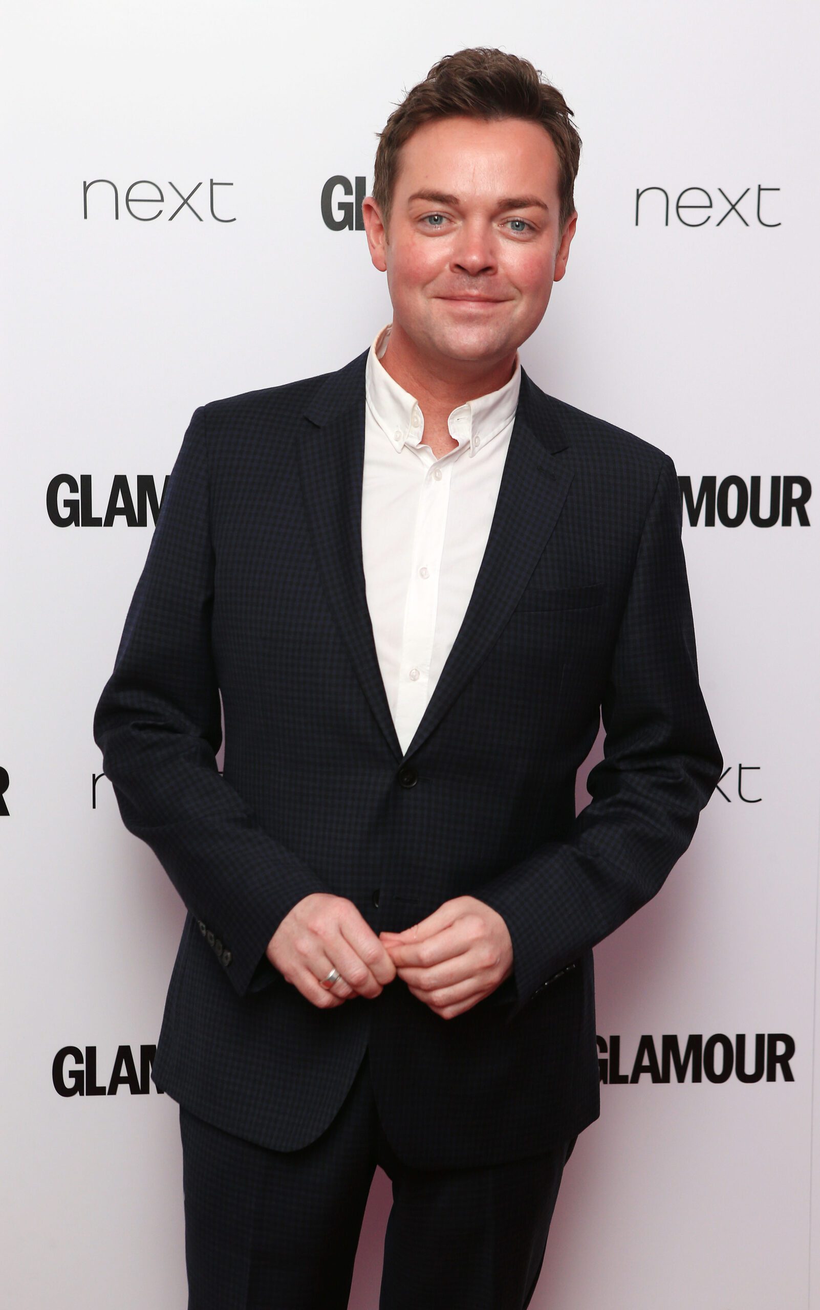 Stephen Mulhern in a tuxedo on red carpet smiling