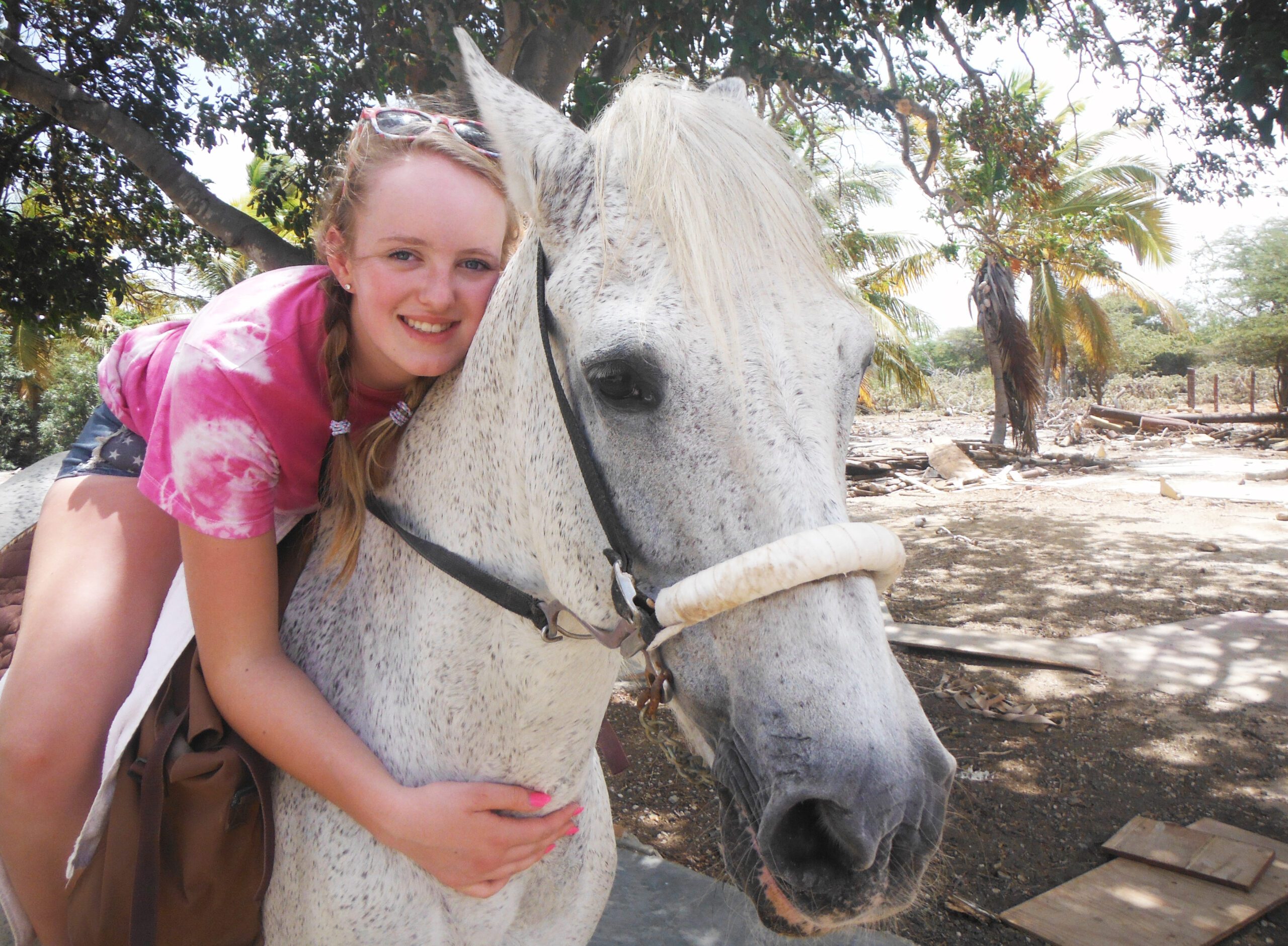 Gracie Spinks cuddling her horse