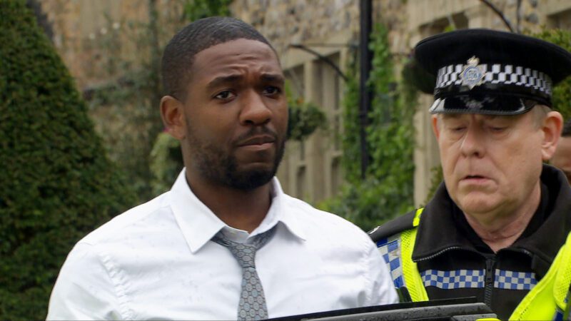 Emmerdale: Ethan looks anxious as he's led into a police car