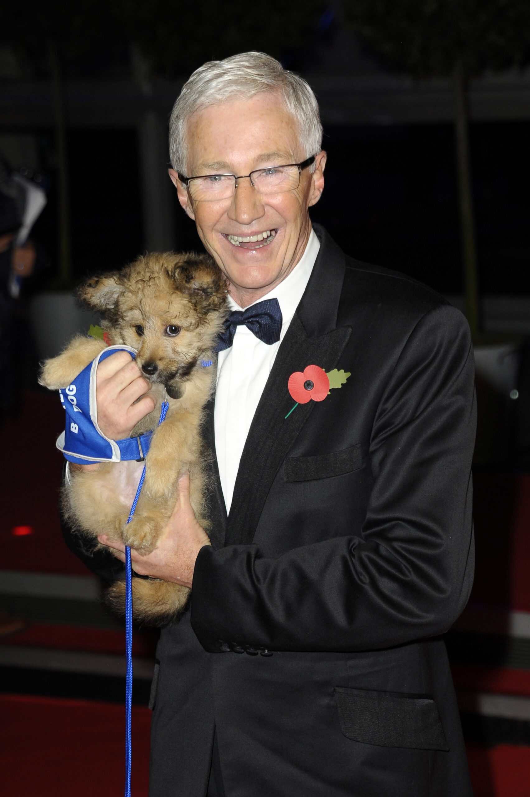 Paul O'Grady holding a dog