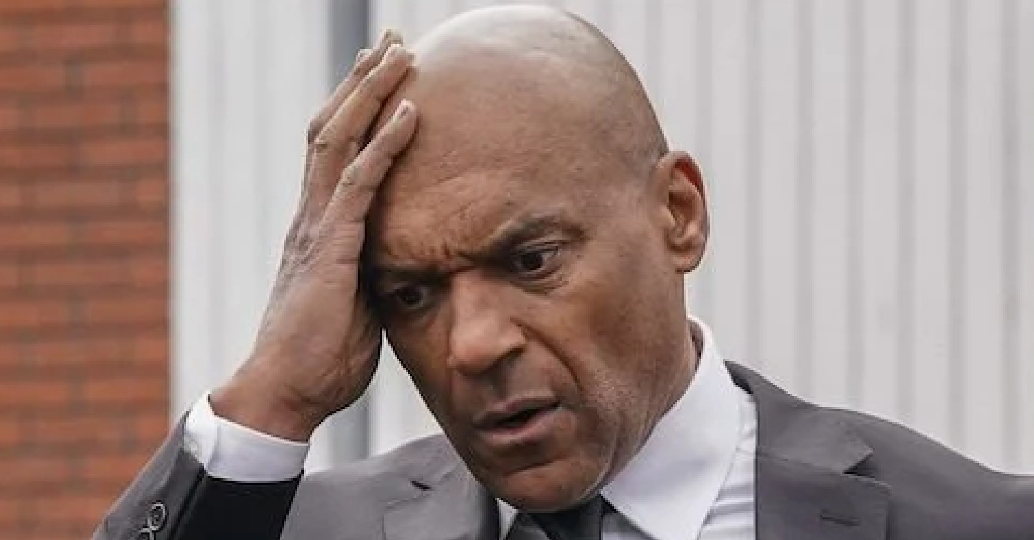 EastEnders comp image: George Knight grabs his head looking worried