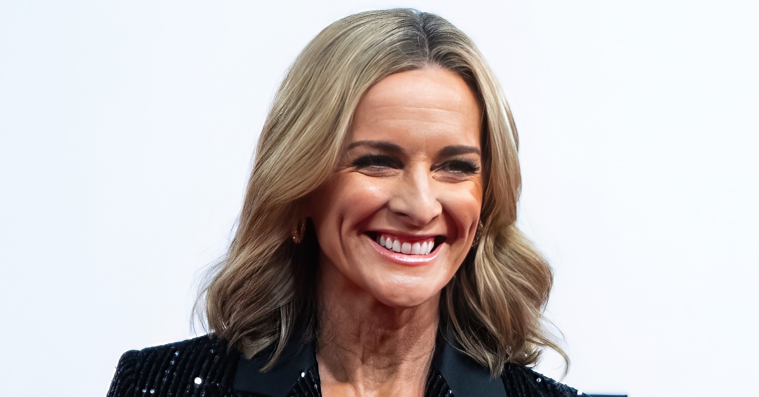 Gabby Logan smiling whilst wearing a sparkly suit