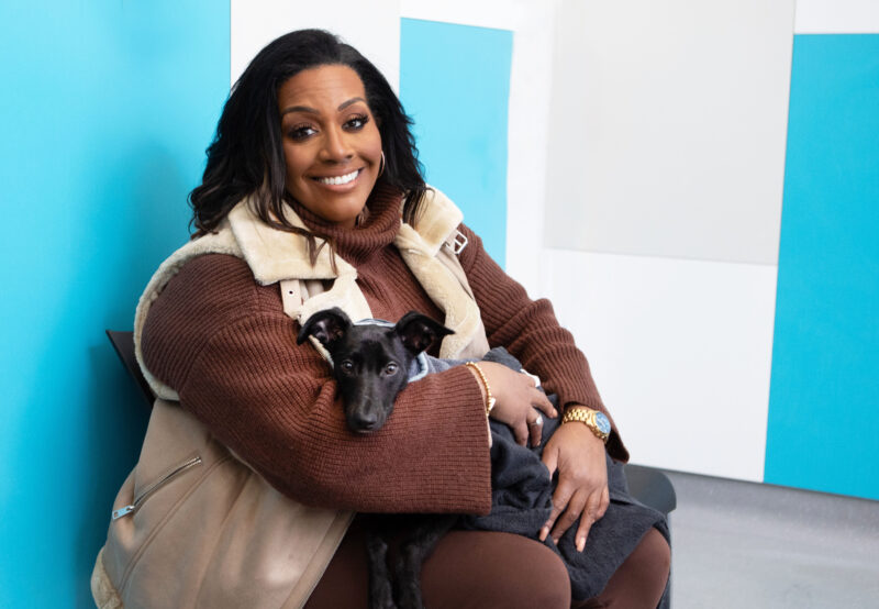 Alison Hammond smiles clutching a dog on For The Love Of Dogs
