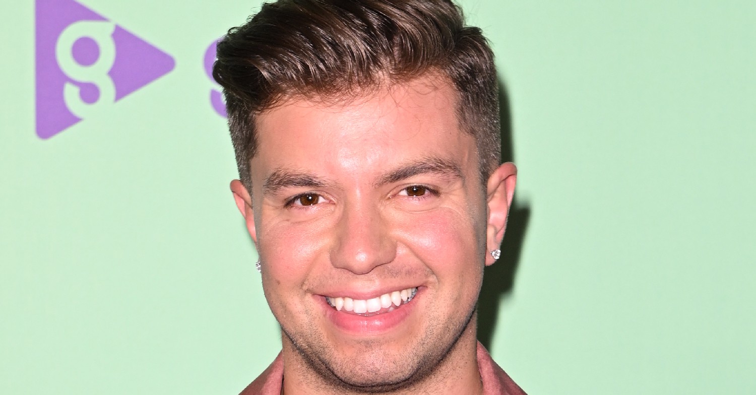 Sonny Jay smiling against a green background