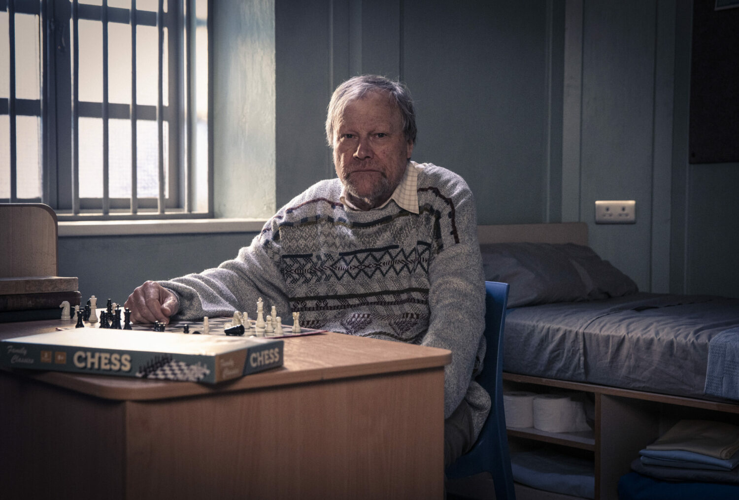 Roy in Coronation Street sits in his prison cell with his chess board