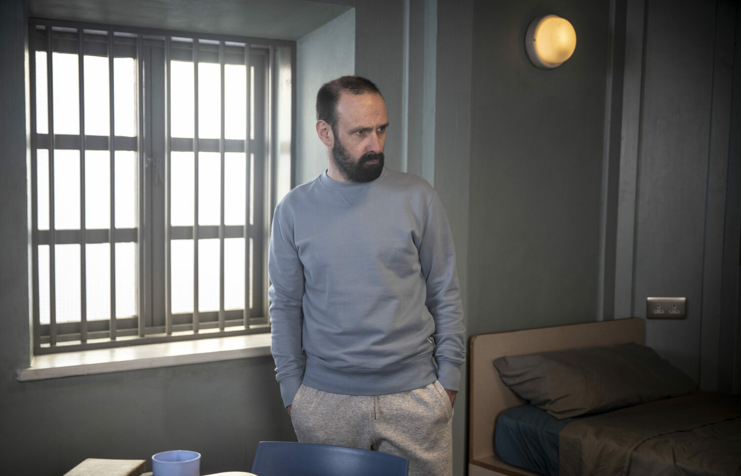 Griff looks vengeful in Coronation Street in Roy's prison cell