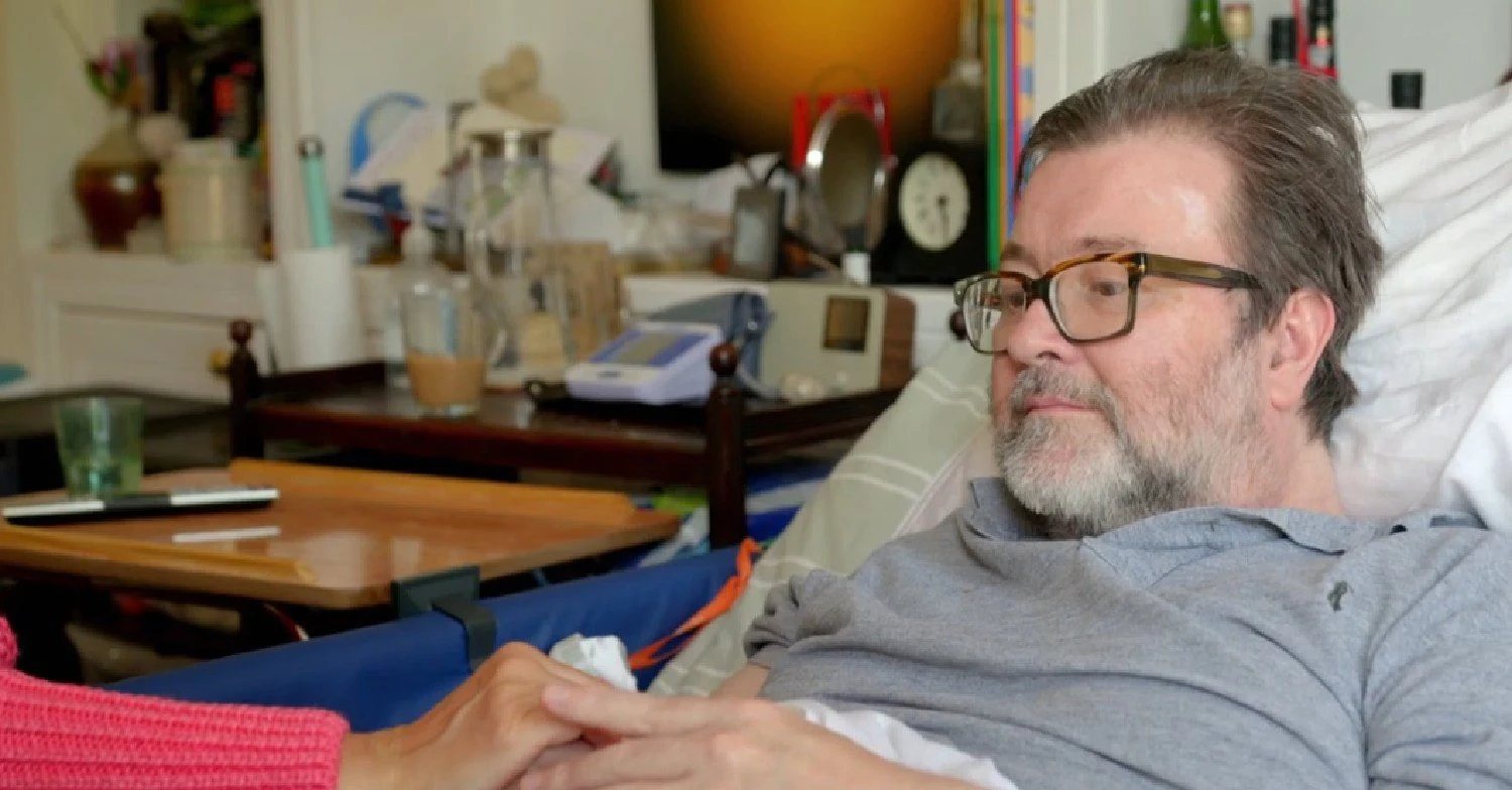 Kate Garraway's husband Derek Draper sat in a bed