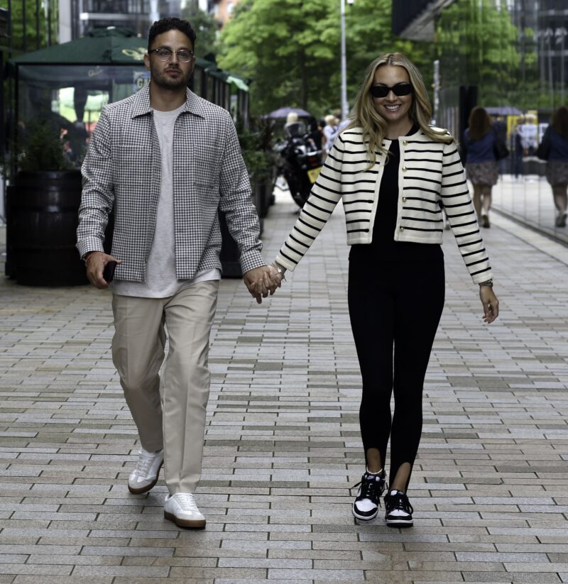 Adam Thomas holding hands with wife Caroline