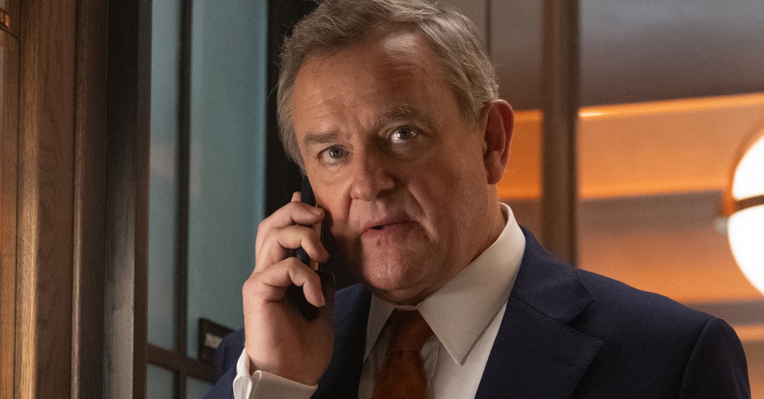 Hugh Bonneville looking serious taking a phone call in character for Douglas is Cancelled