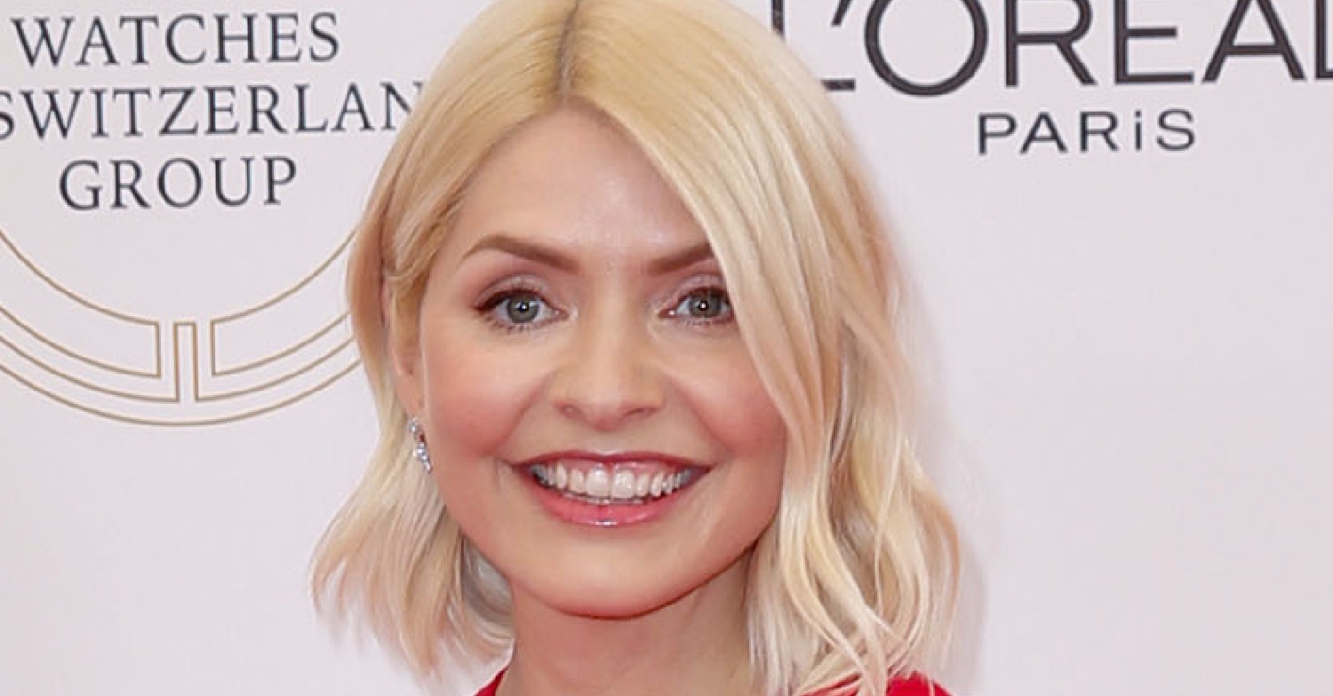 Holly Willoughby smiling in a red dress