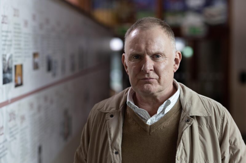 Robert Glenister looking serious in a locker room, as Tony in The Night Caller