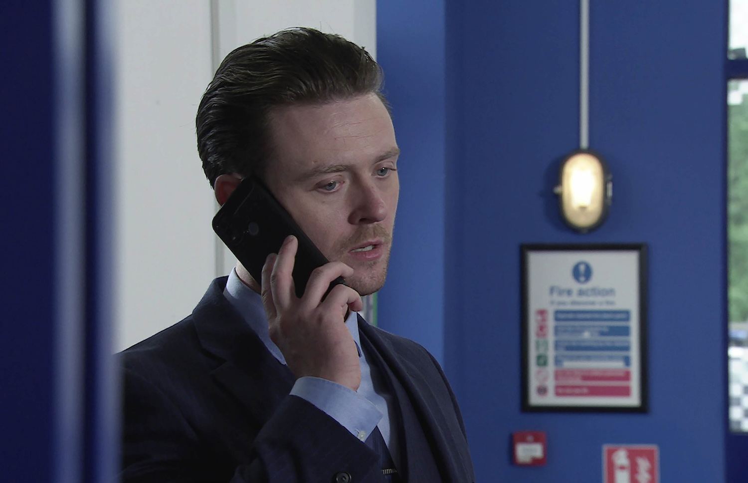 Joel on the phone in Corrie