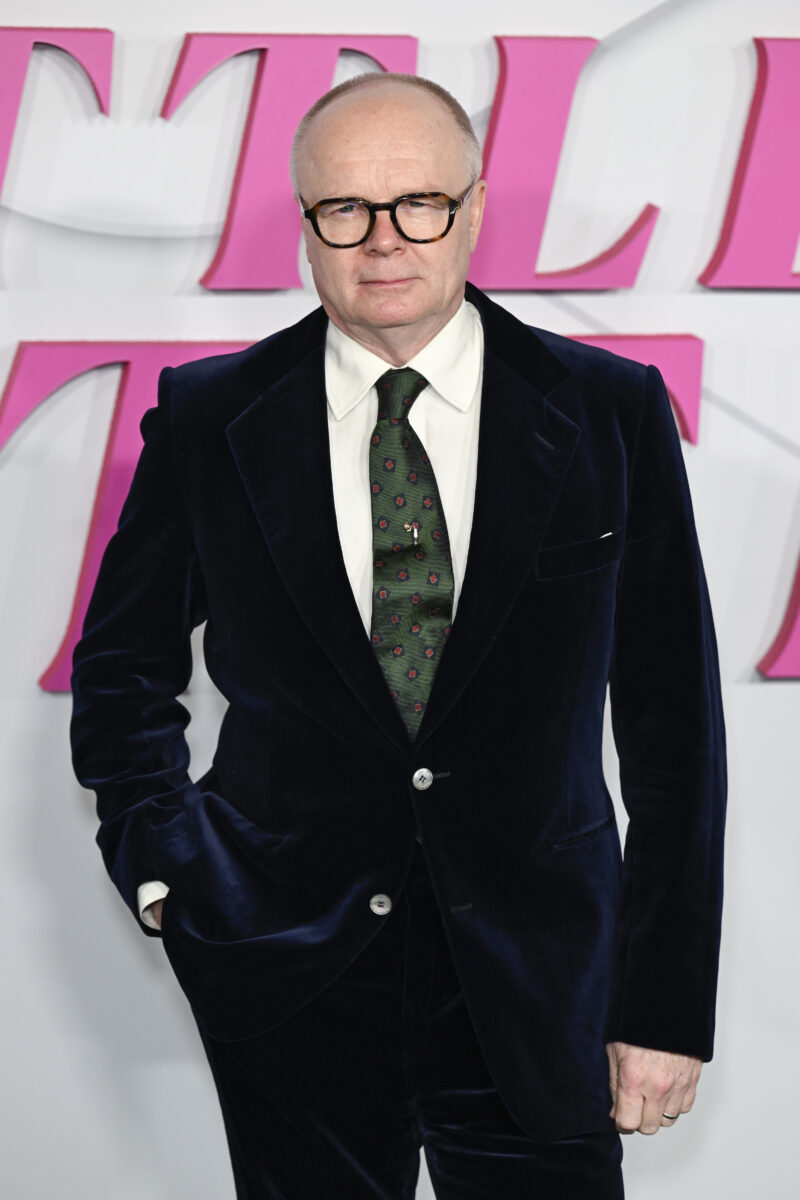 Jason Watkins wearing a suit and glasses on the red carpet