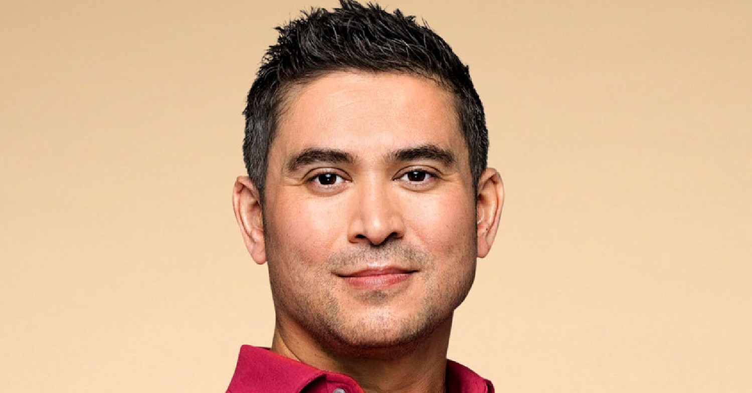 Rav Wilding eyes to camera in a deep pink shirt