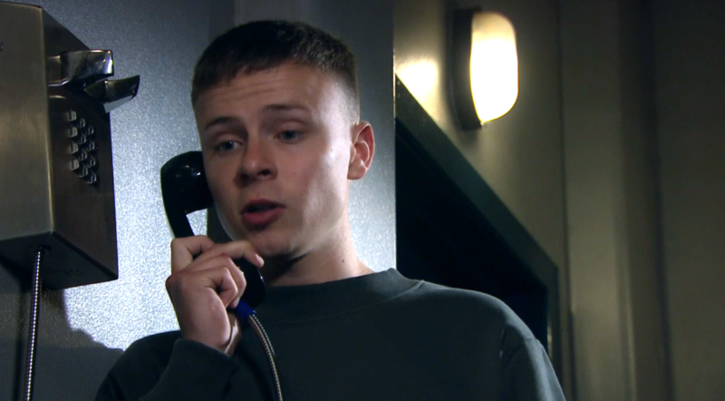 Samson looks worried as he makes a phone call from prison in Emmerdale