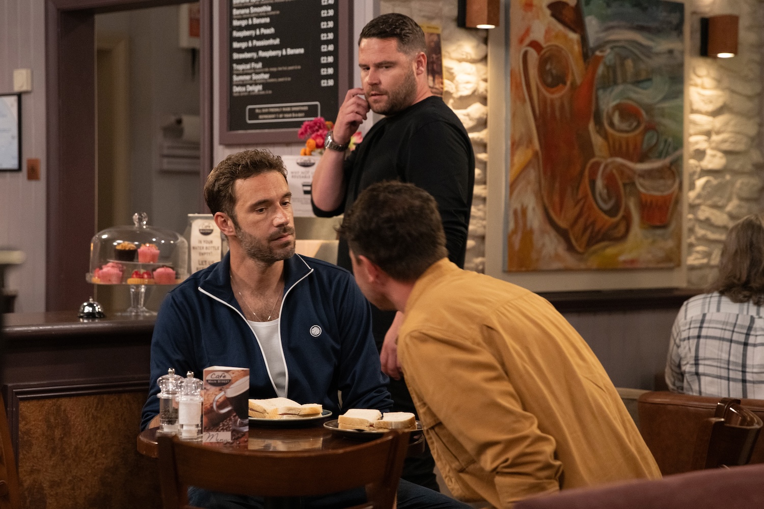 Aaron watches John on a date in Emmerdale