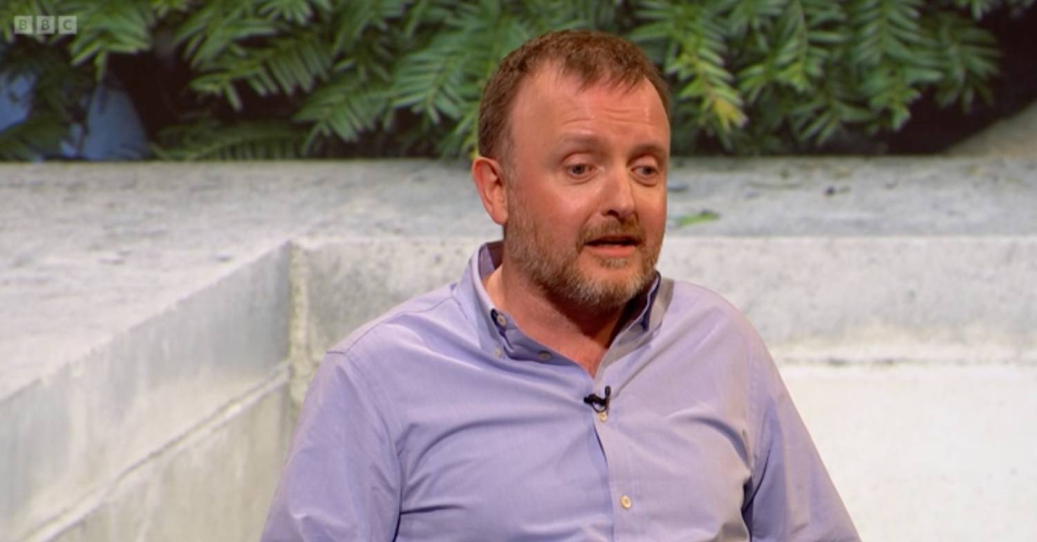 QI appearance man in purple shirt