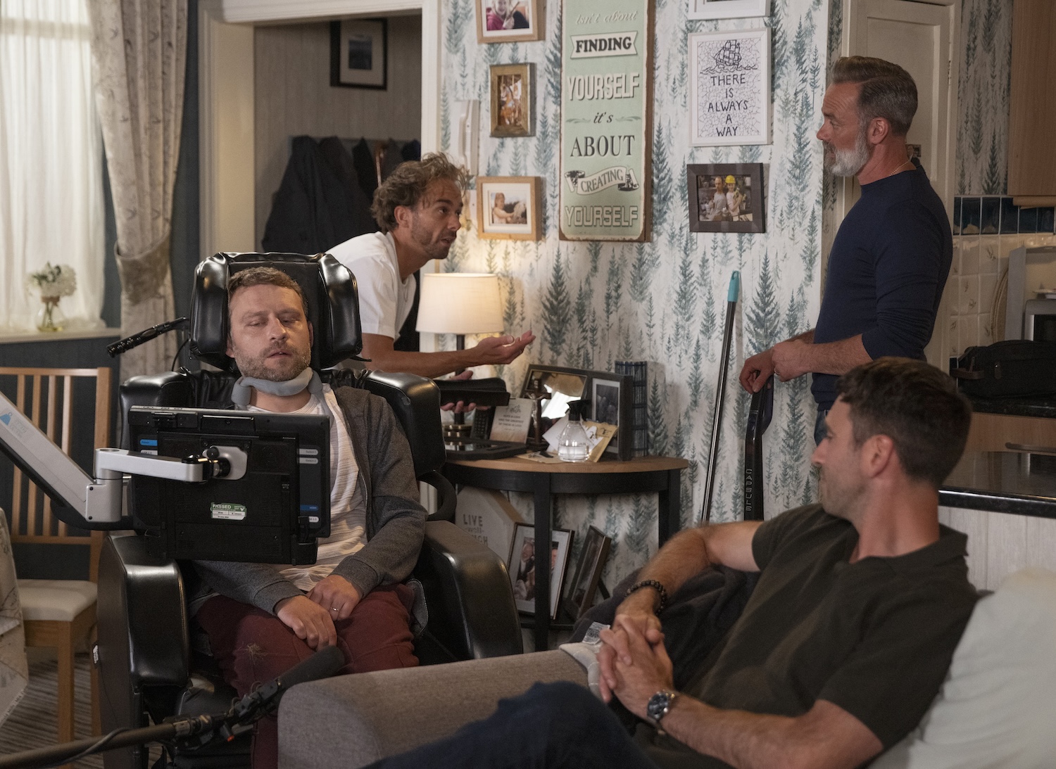 Billy stands in the background as Paul and Kit talk