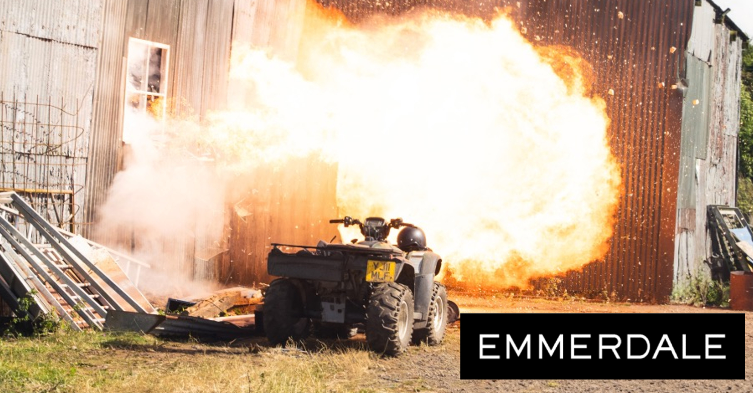 Emmerdale's logo and a barn on fire