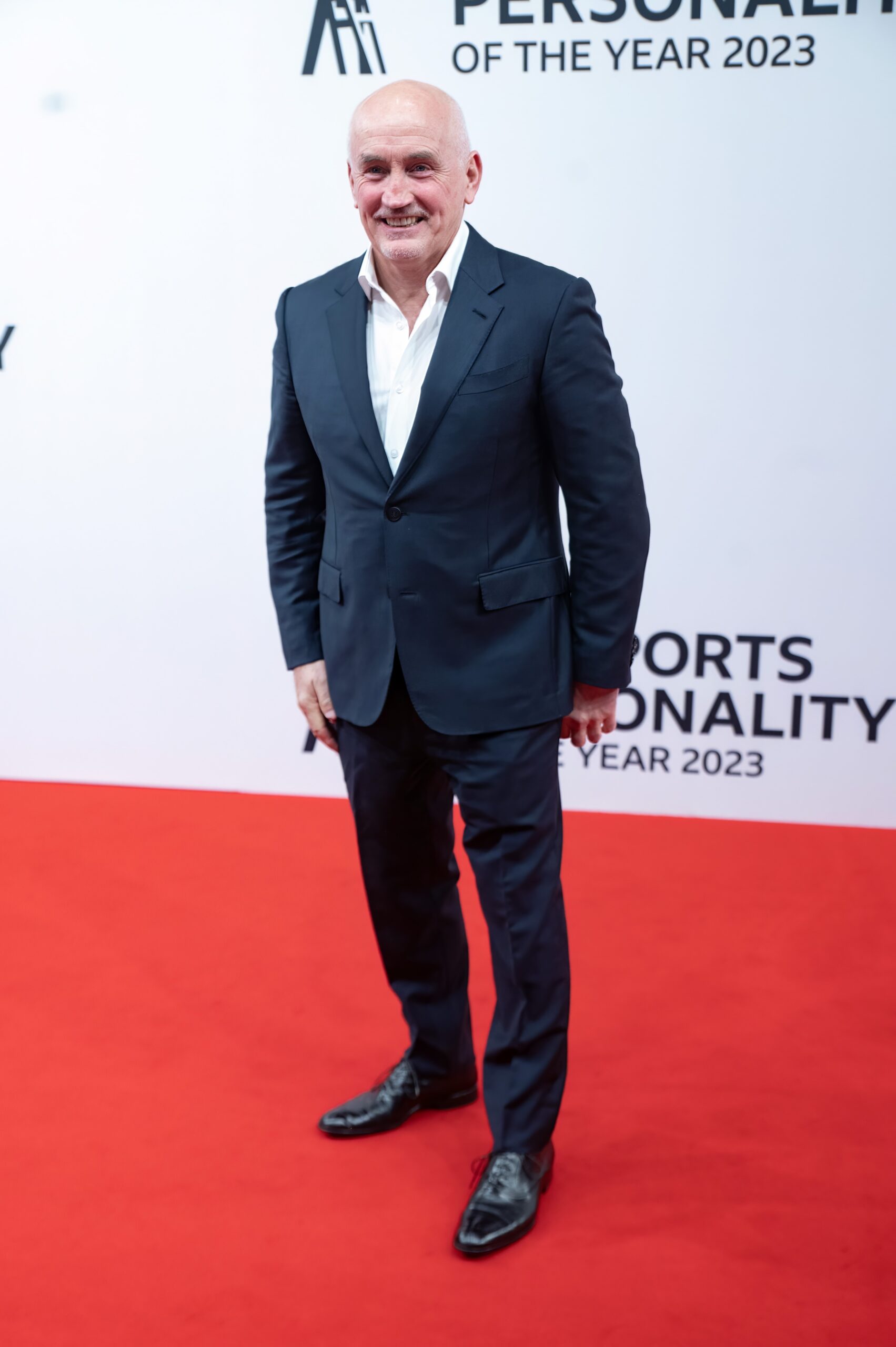 Barry McGuigan smiling on red carpet at event