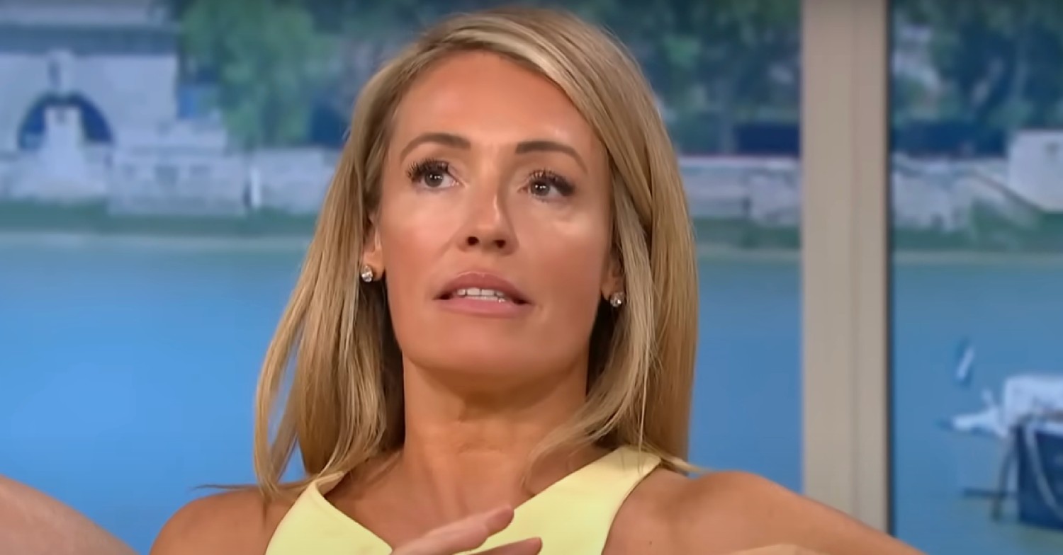 Cat Deeley looking up in a yellow dress on This Morning