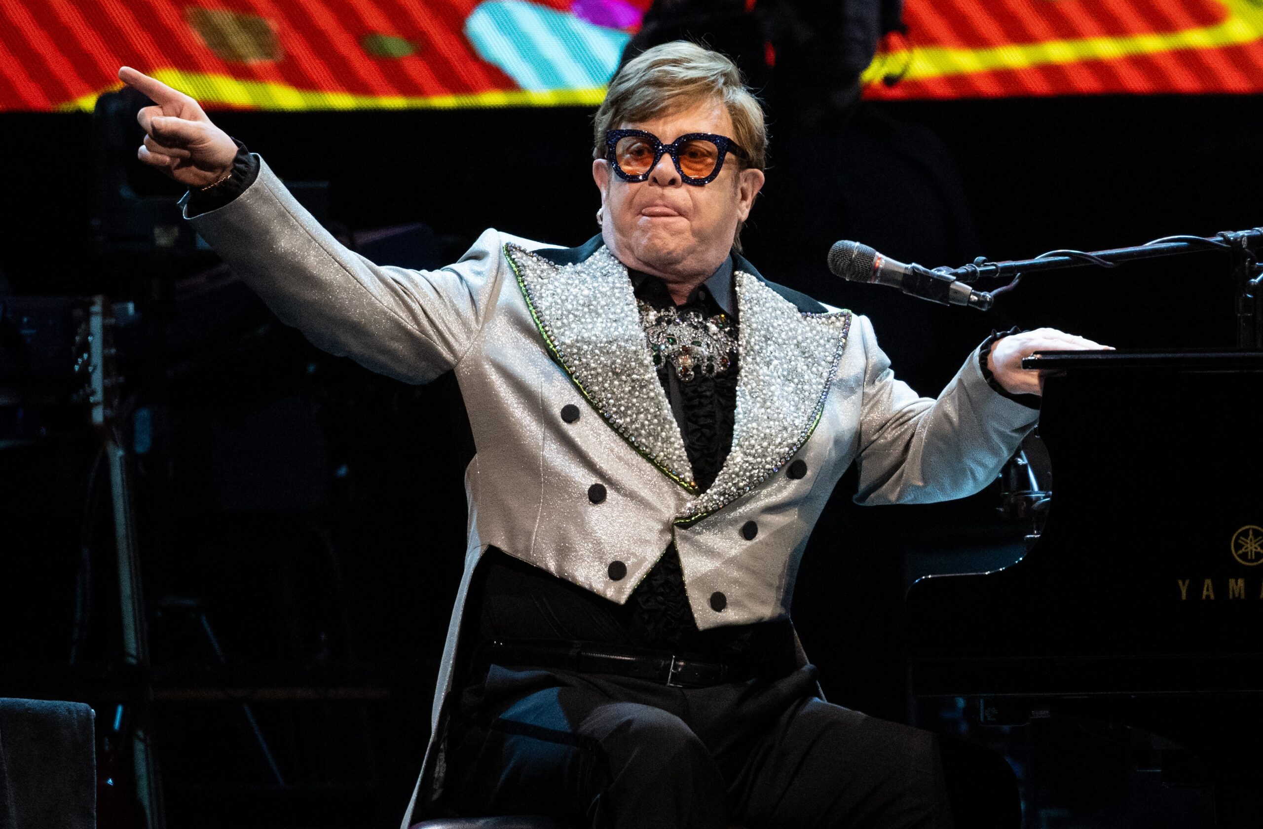 Elton John sat at piano on stage