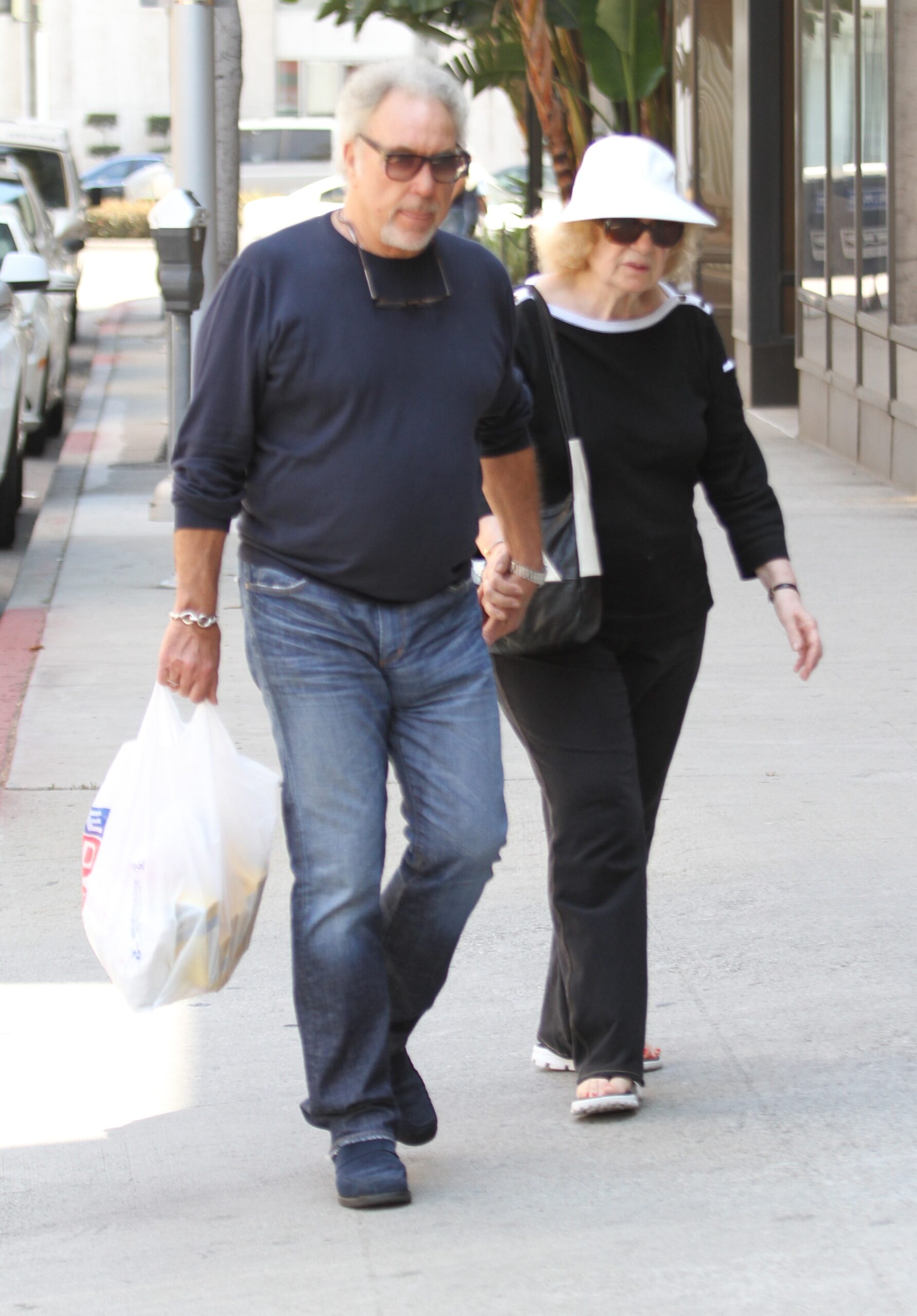 Tom Jones and Melinda Woodward holding hands
