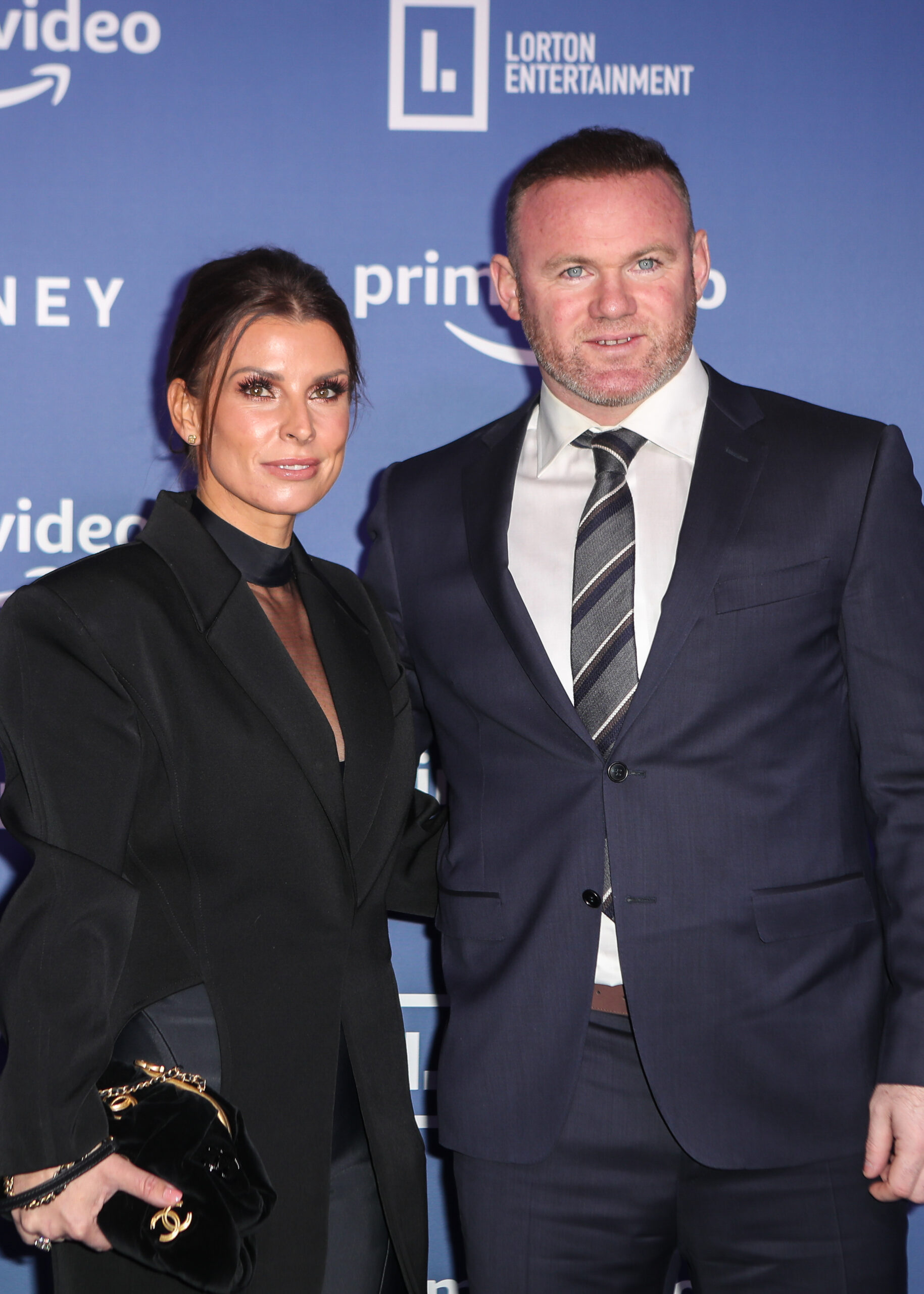 Coleen Rooney and Wayne Rooney smiling at event