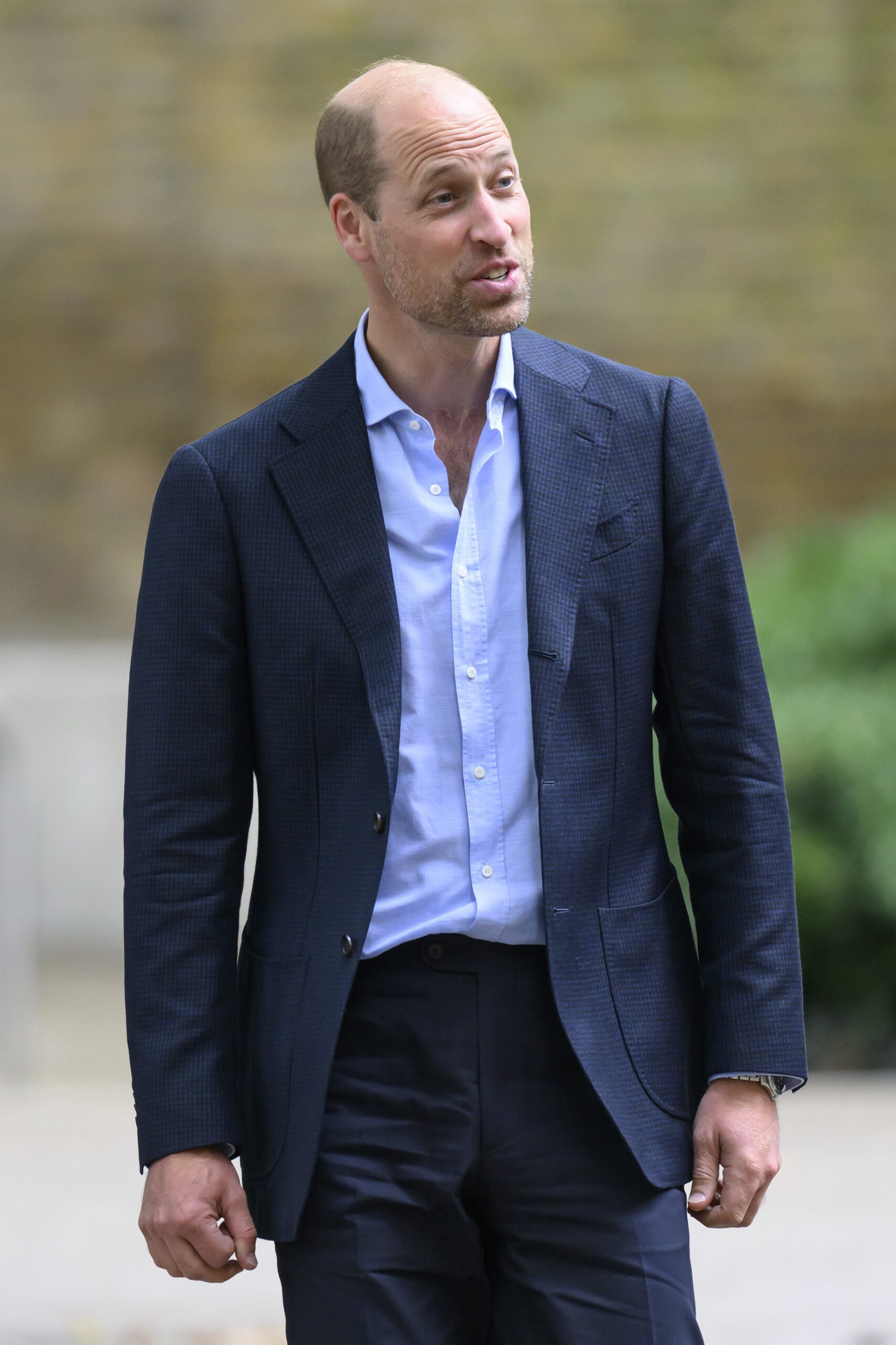 Prince William in blazer with beard on royal visit