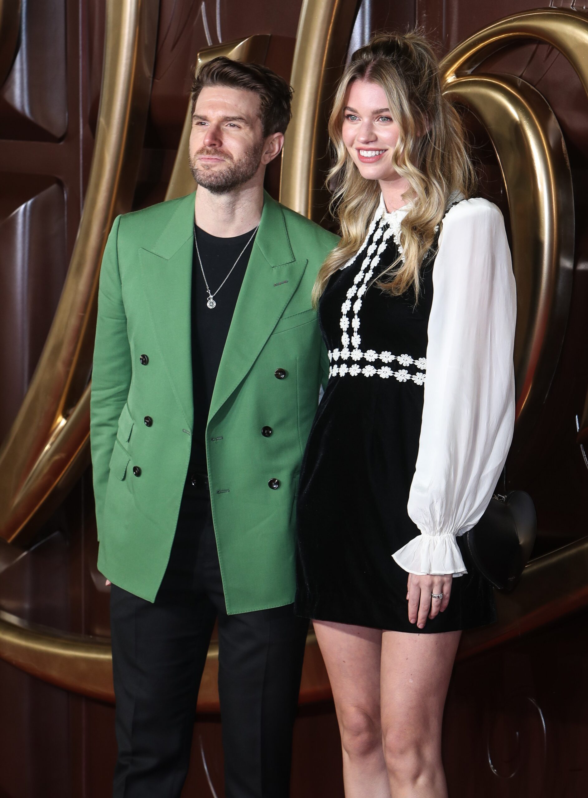 Joel Dommett smiling with wife Hannah at movie premiere