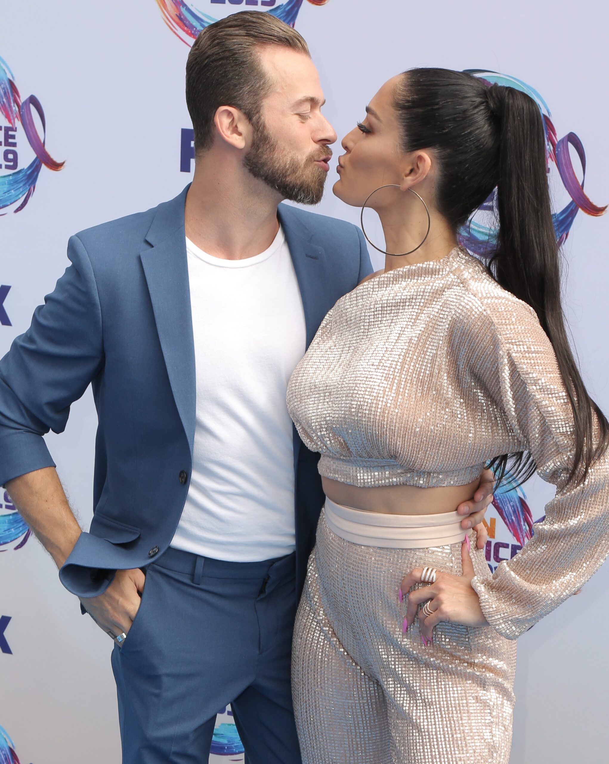 Artem Chigvintsev and wife Nikki Bella kissing at event