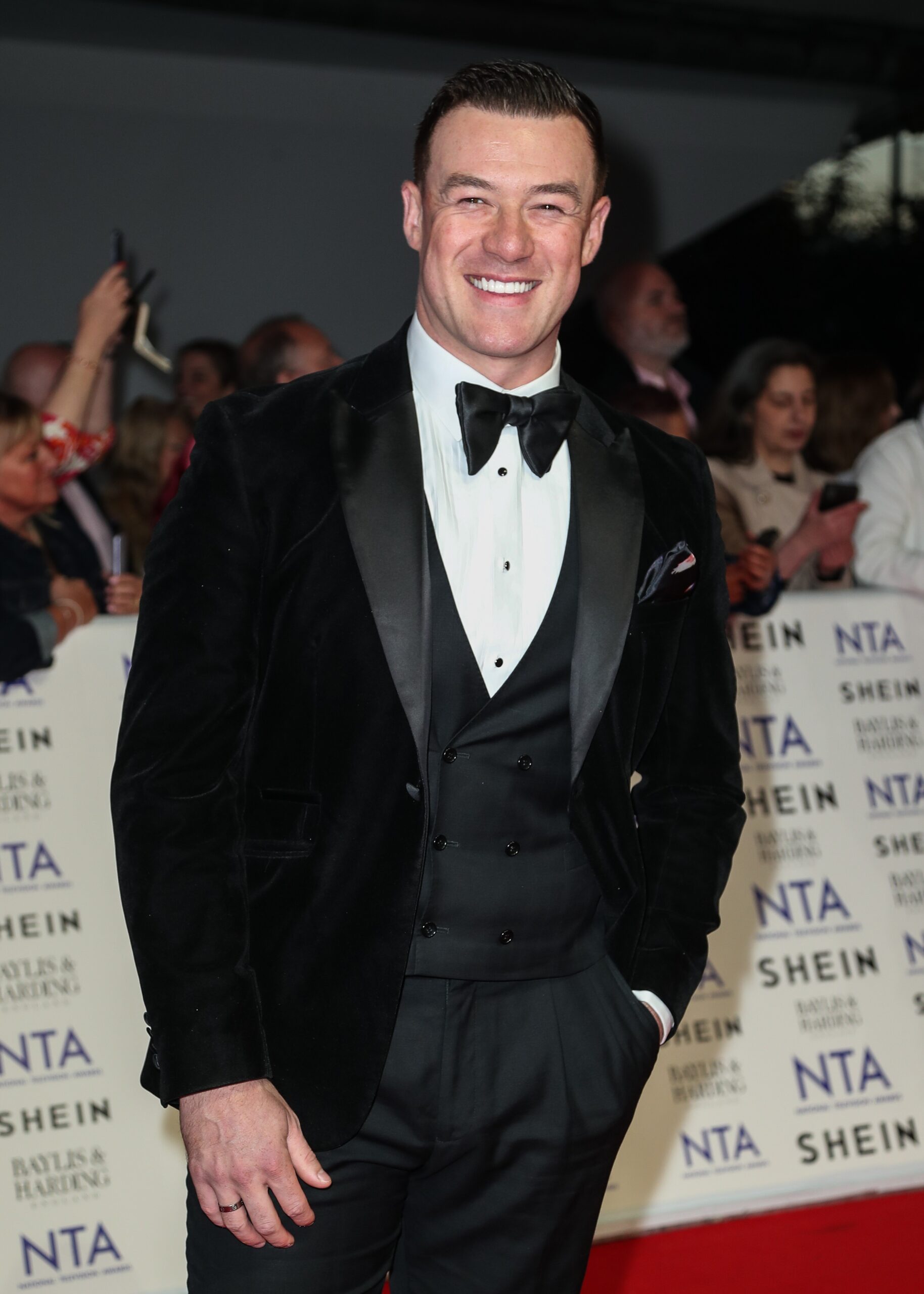 Kai Widdrington smiling in suit at the NTAs