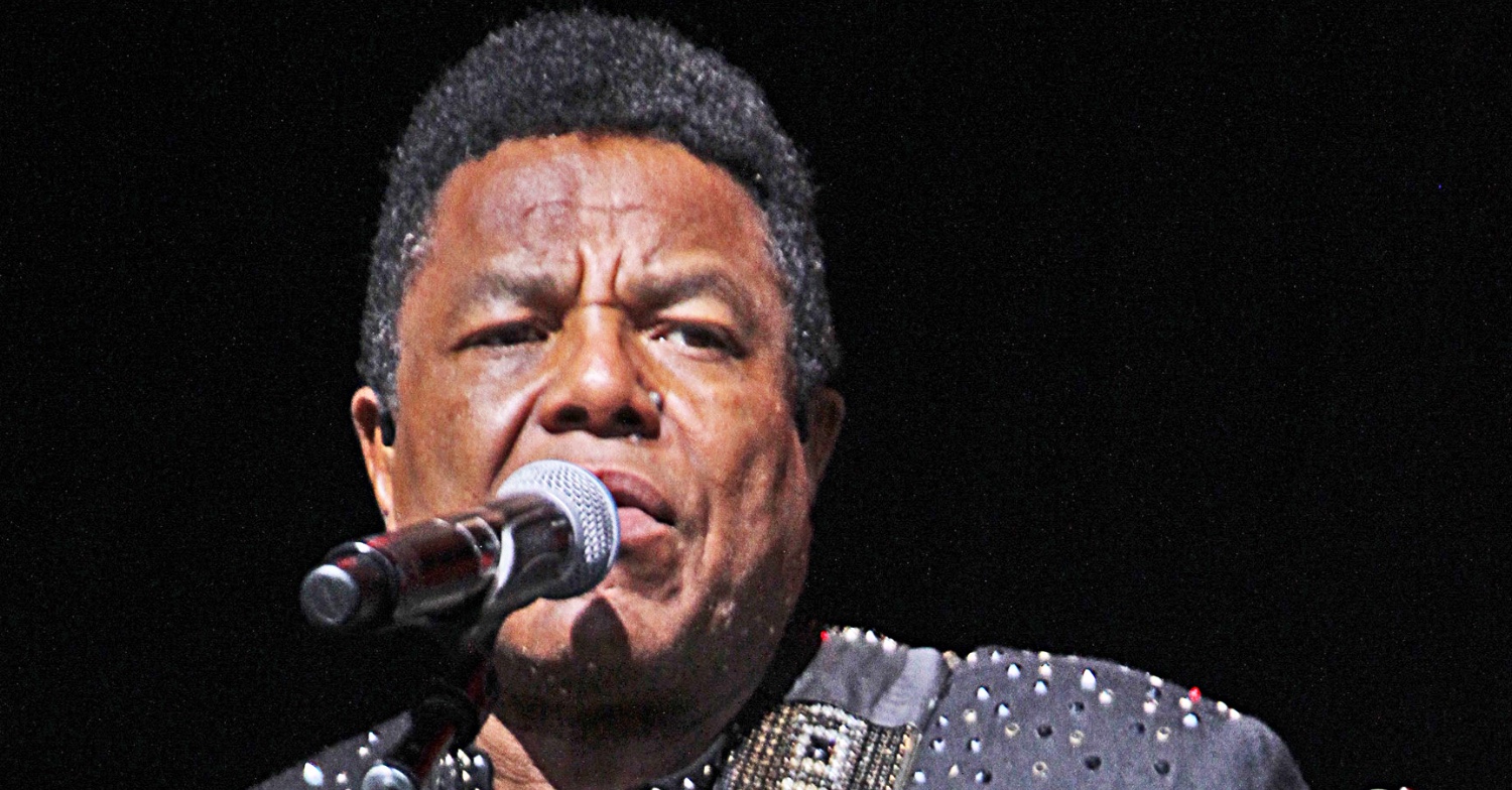 Tito Jackson singing into a microphone