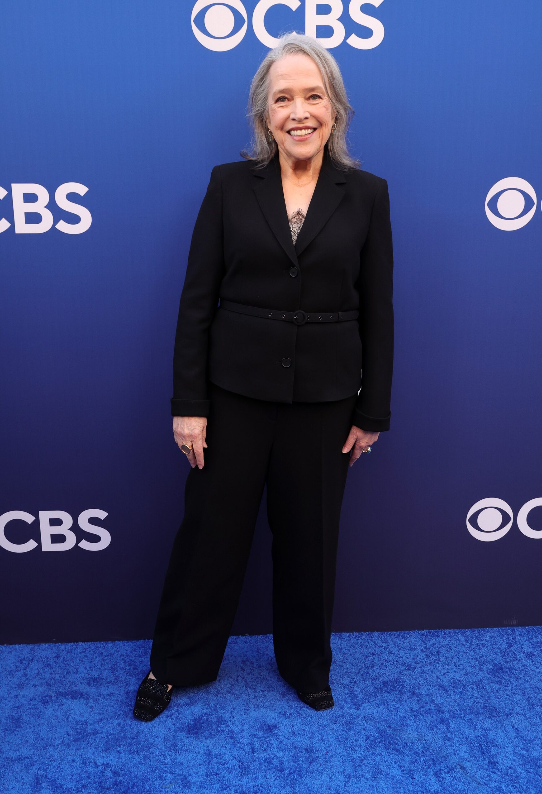 Kathy Bates smiling in black suit at event