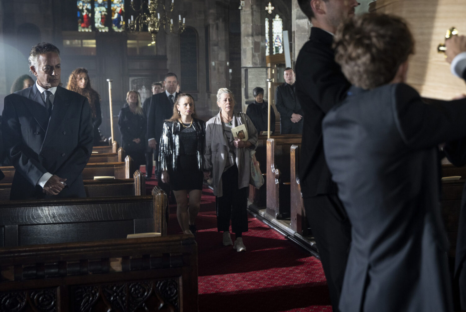 Gemma and Bernie walk behind Paul's coffin in Corrie