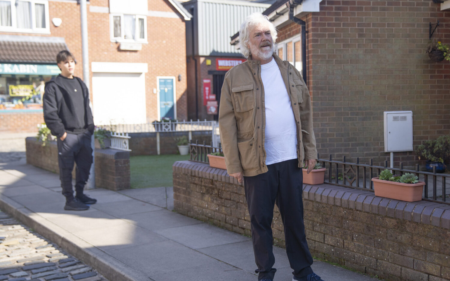 Stu walking away from Mason on the Street