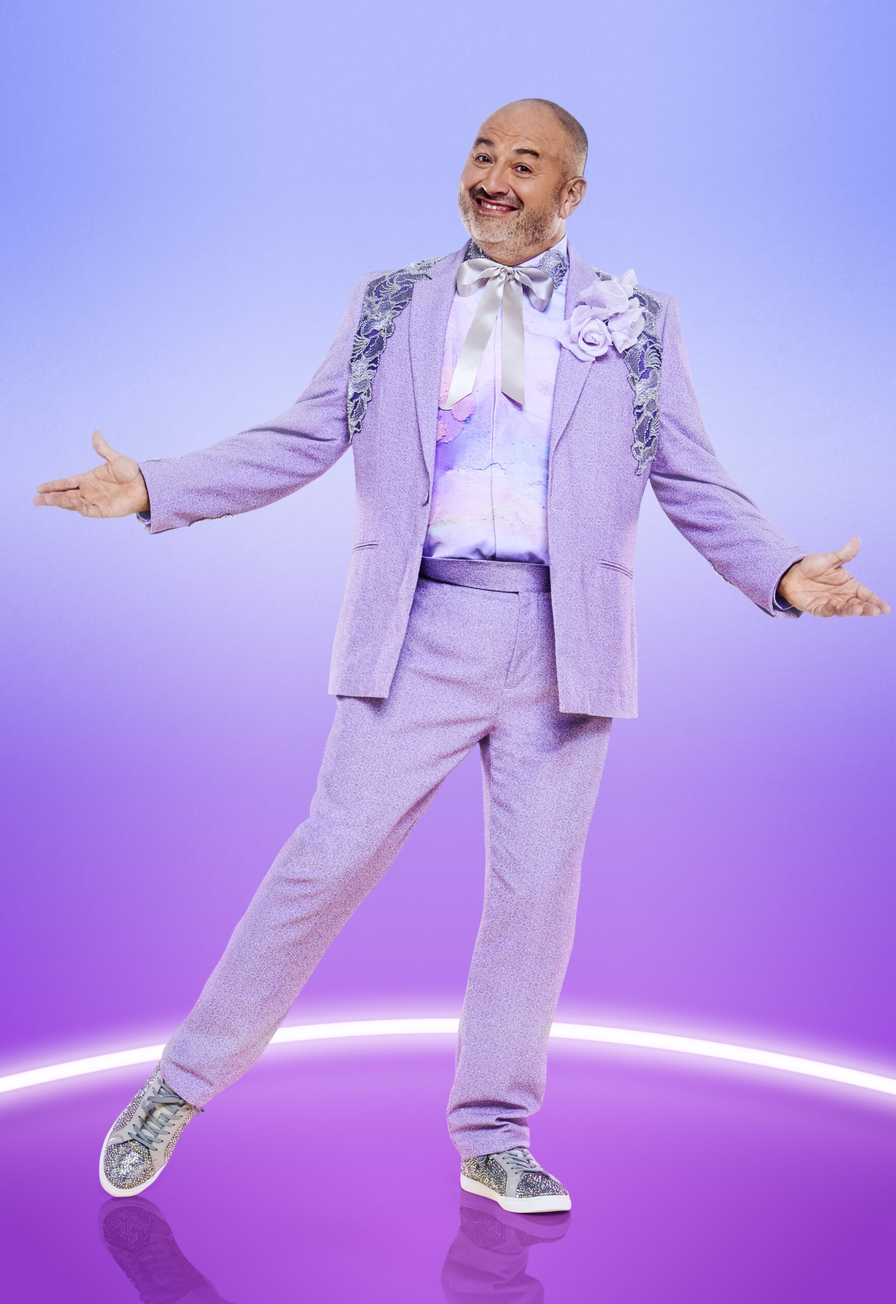 Wynne Evans smiling in purple suit in Strictly promo picture