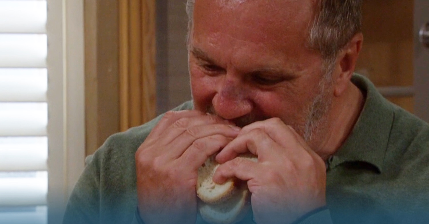 Emmerdale's Will is biting into a sandwich