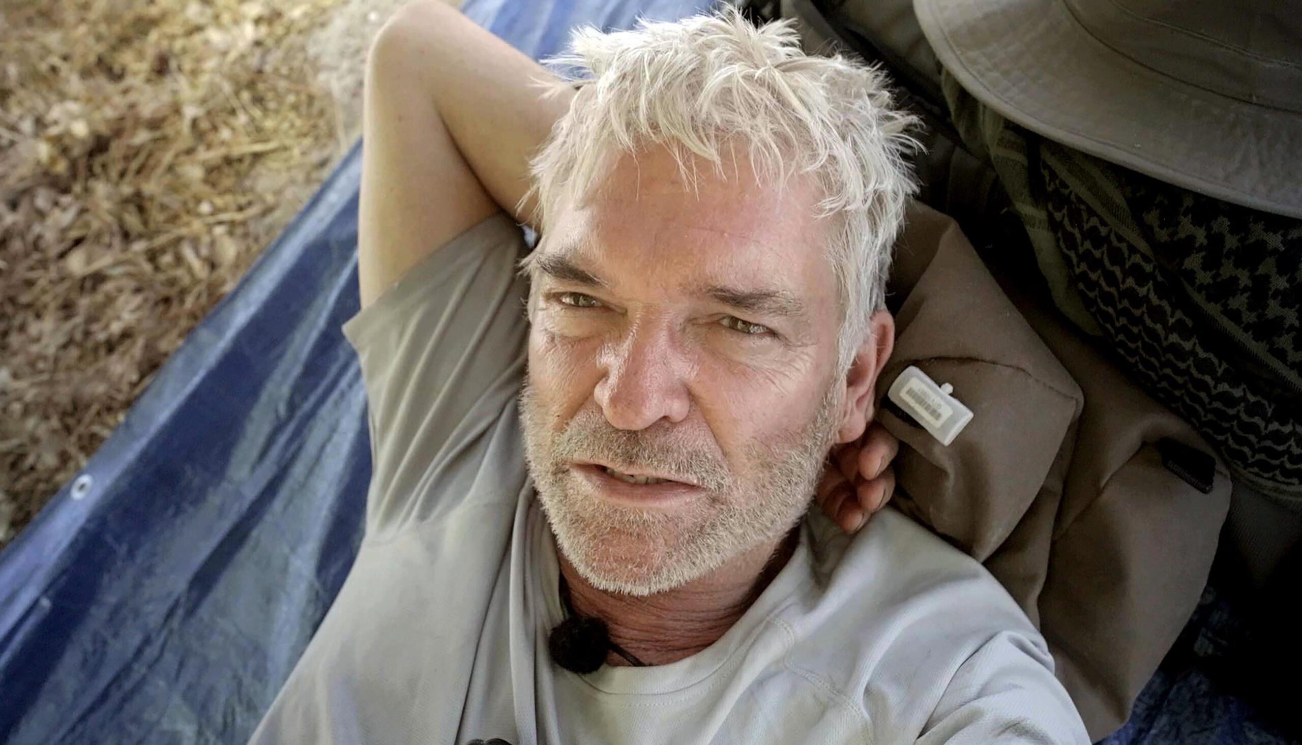 Phillip Schofield with his head resting on his arm on Cast Away