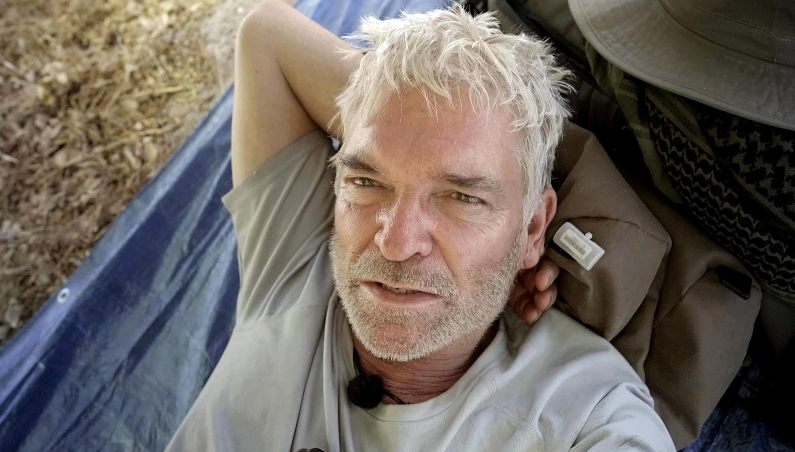 Phillip Schofield with his hand behind his head on Cast Away