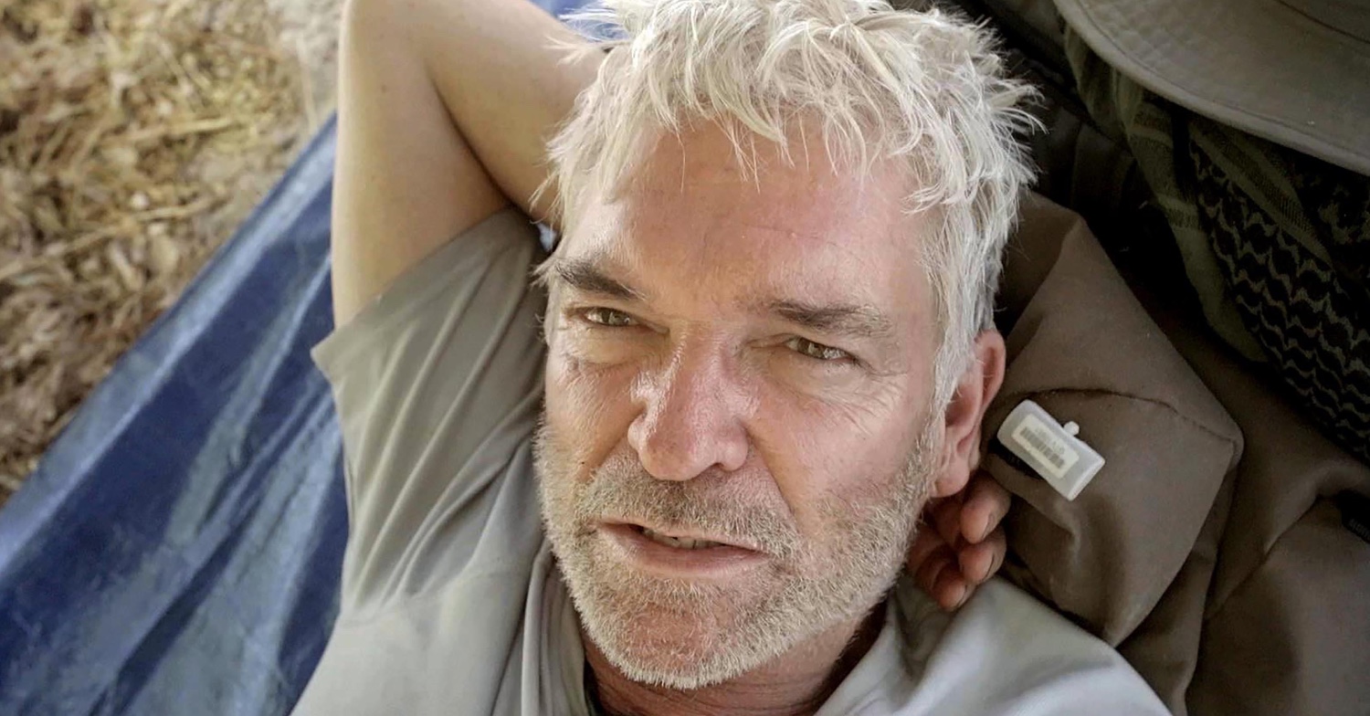 Phillip Schofield with his hand behind his head on Cast Away