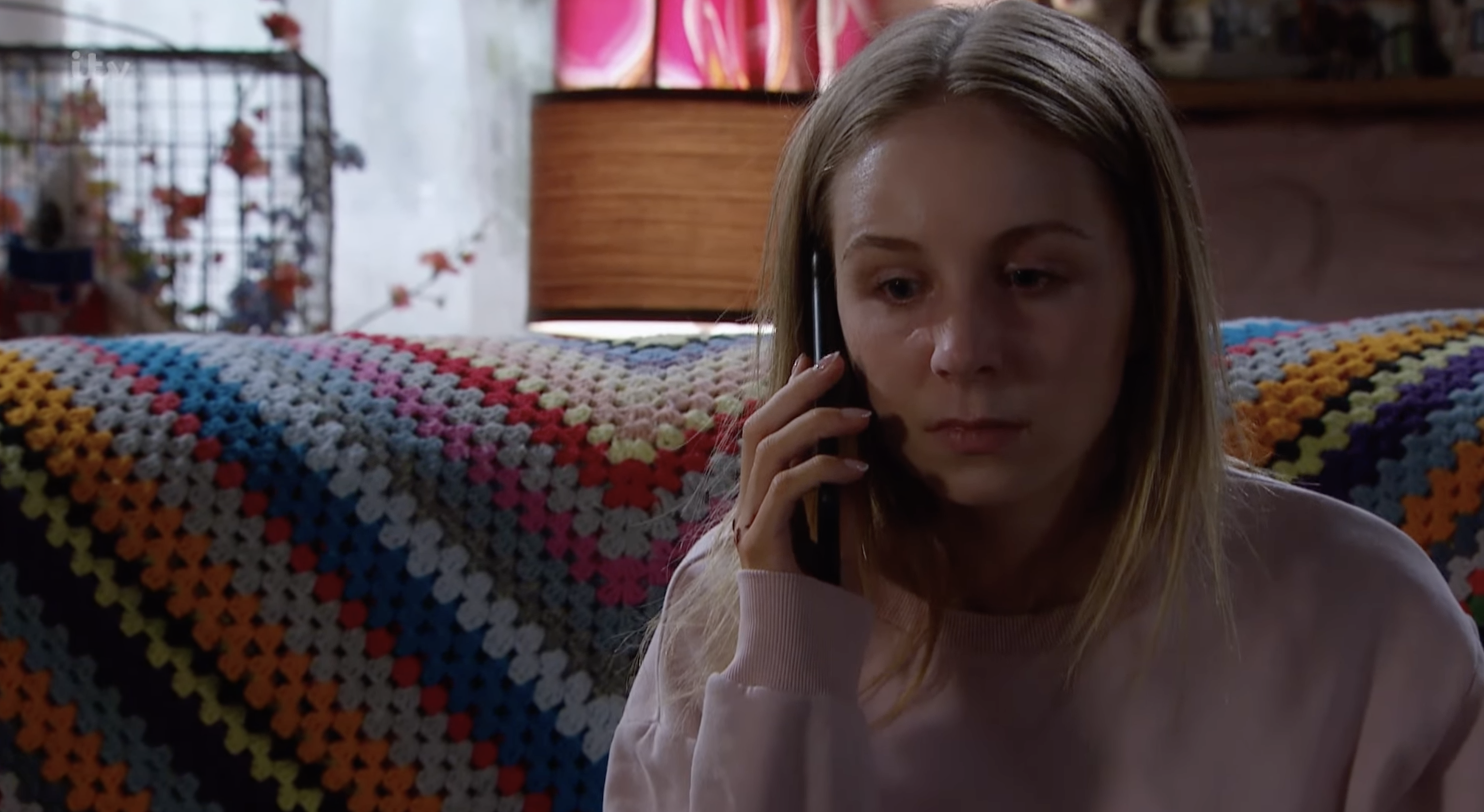 Belle looks concerned in Emmerdale on the phone