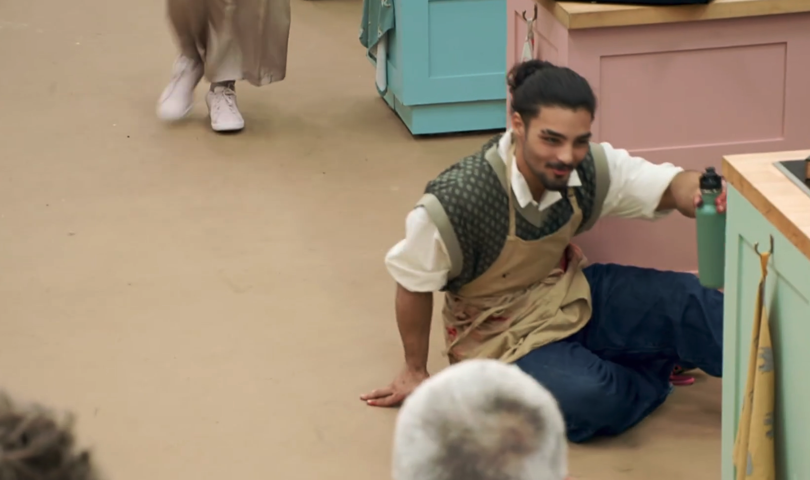 Dylan falls off his chair on the Bake Off