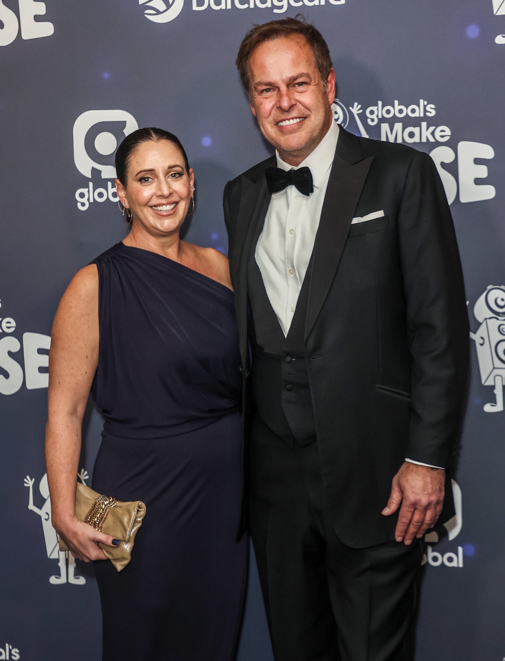 Peter Jones and partner Tara smiling at event