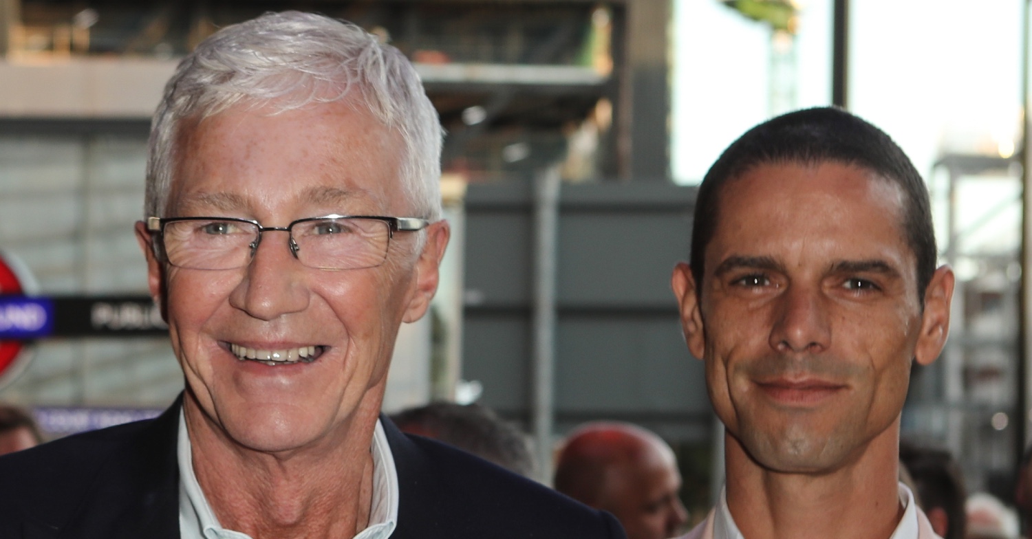 Paul O'Grady smiling beside husband Andre Portasio