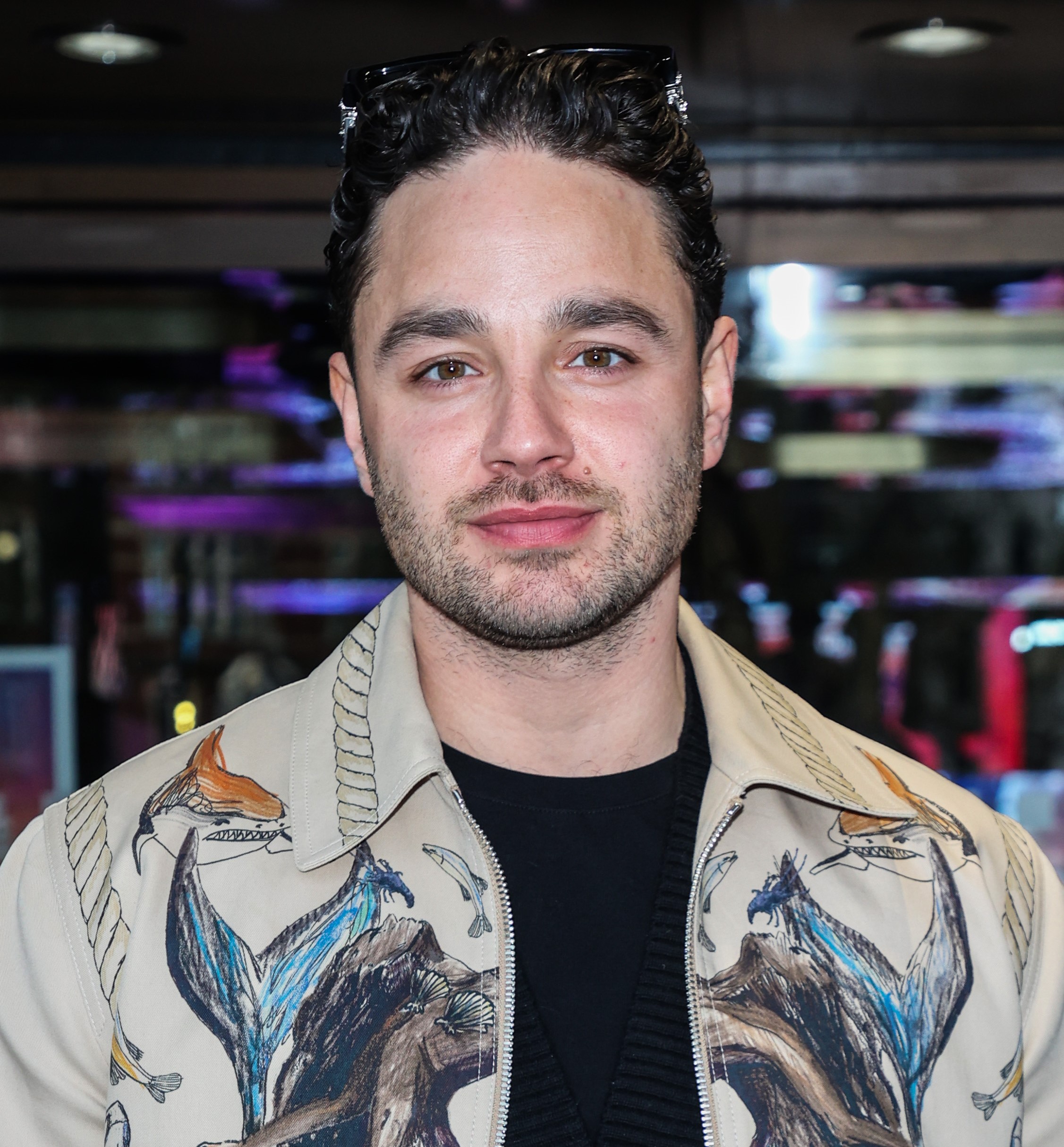 Adam Thomas posing at event