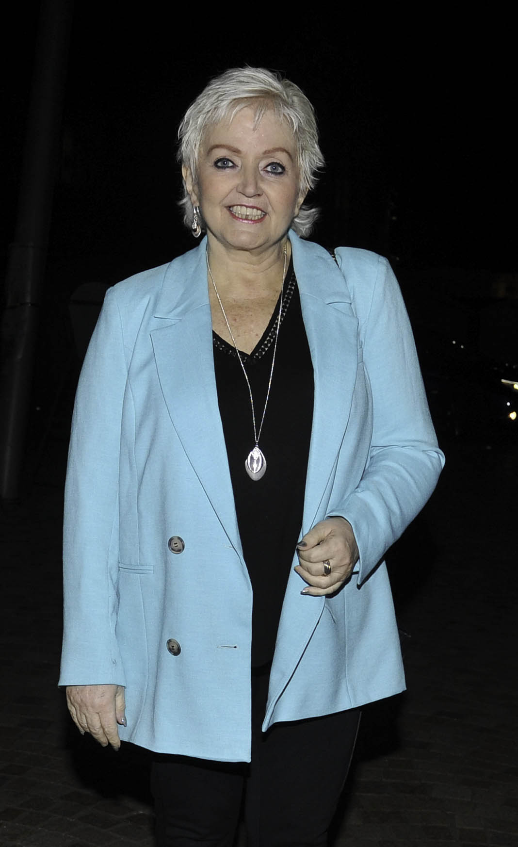 Linda Nolan wearing a bright blue jacket smiling