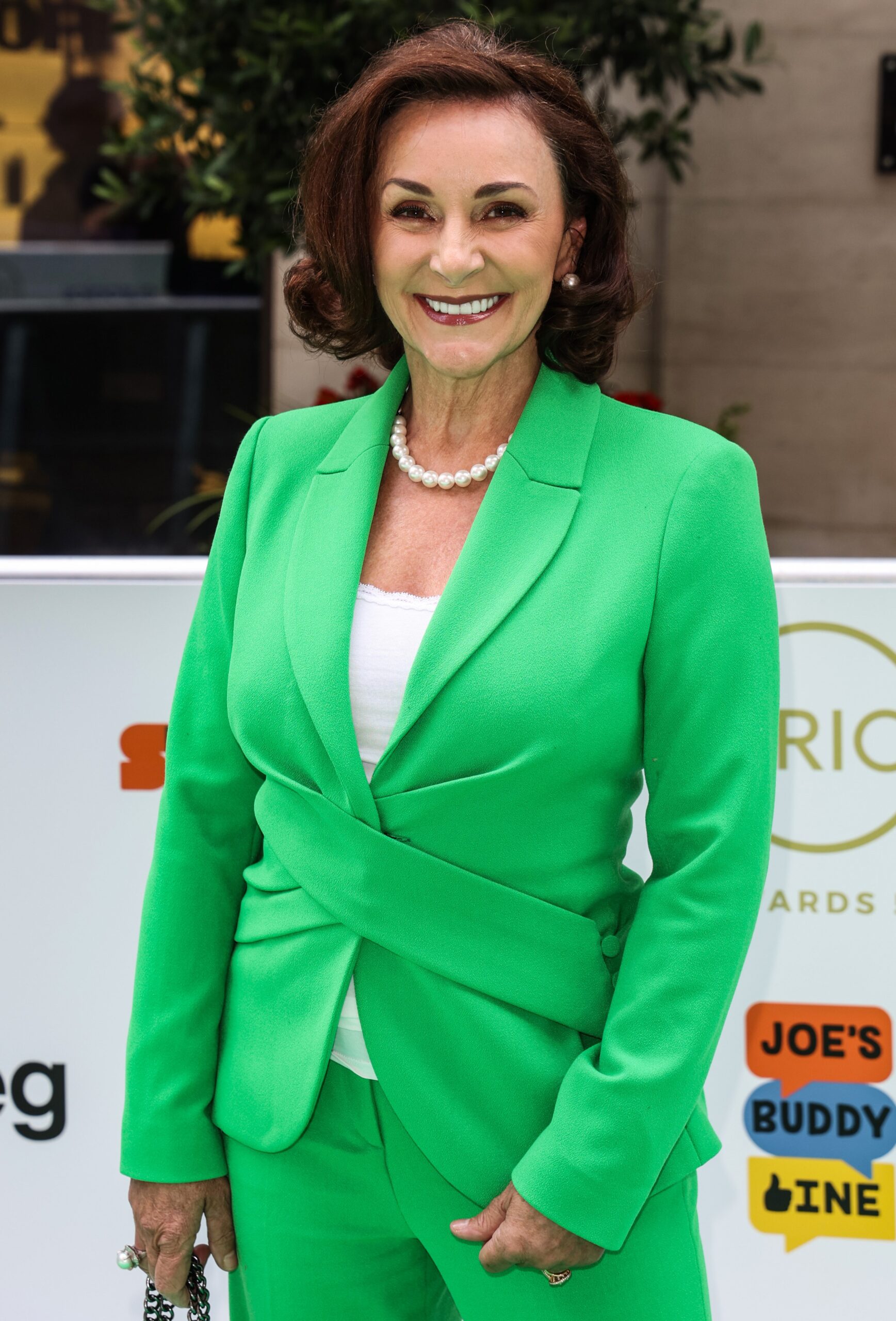 Shirley Ballas smiling in green suit at event